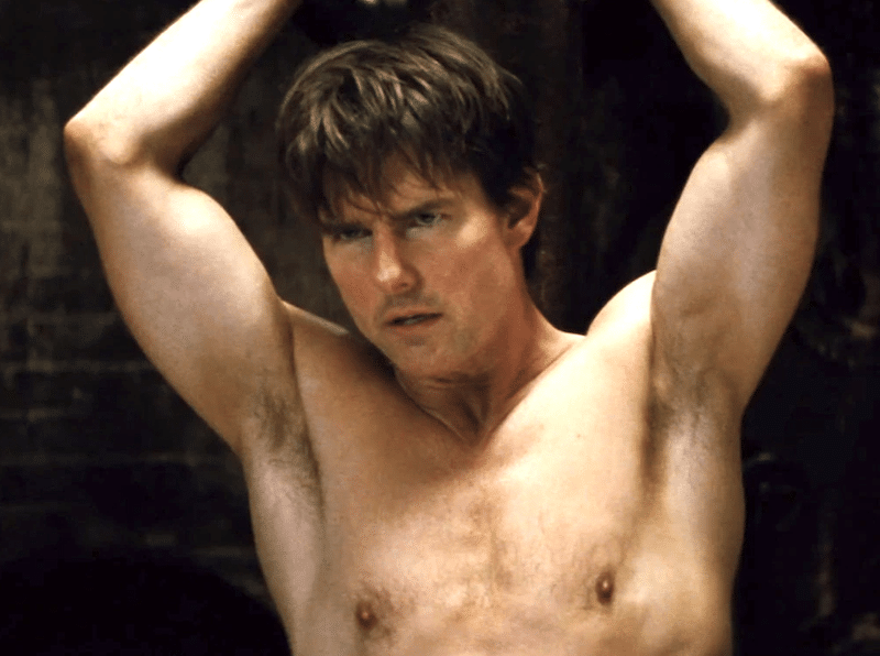 Aged male surfers gape as Tom Cruise takes shirt off on beach